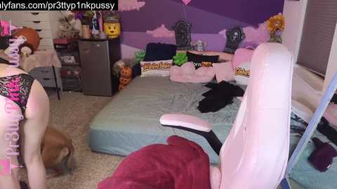 Media: A video of a messy, pastel-themed bedroom with a plush chair, a bed covered in clothes, stuffed animals, and a pink canopy.