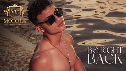 Media: Video of a shirtless, muscular, tan-skinned man with short curly hair, wearing dark sunglasses, standing near a rippling pool. Background includes a logo and text reading \"Be Right Back.\