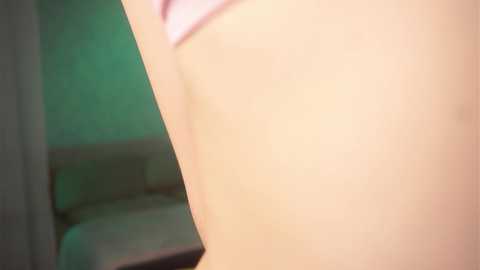 Media: Video of a close-up of a person's upper back, featuring a pale, smooth skin tone. The background shows a blurred, greenish wall and a partially visible white object.