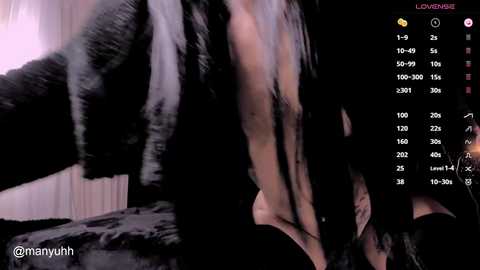 Media: Video of a partially nude, light-skinned woman in a black fur coat, with a blurred background. Streaming statistics overlay shows viewer count.