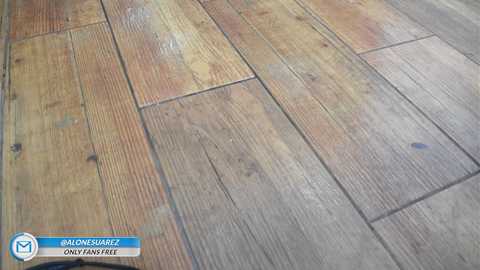 Media: A video of a wooden floor with varying shades of brown, showing the grain and texture of the planks. The floor has a rustic, weathered look. A watermark with text reads \"@ALONESEAMERZ OnlyFans Free.\