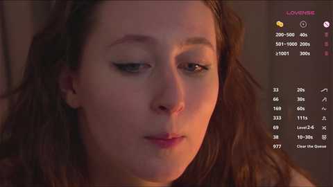 Media: Video of a young woman with fair skin and brown hair, looking contemplative. The background is dimly lit, with a menu interface featuring video settings on the right.