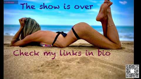 Media: A video of a blonde woman in a black bikini lying on her stomach on a sandy beach, with the ocean in the background. Text reads: \"The show is over. Check my links in bio.\