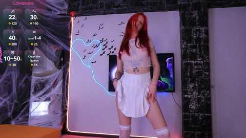 Media: Video of a pale-skinned woman with long red hair, dressed in a revealing white maid outfit, standing confidently in a dimly lit room with a black wall and glowing heart-shaped neon lights.