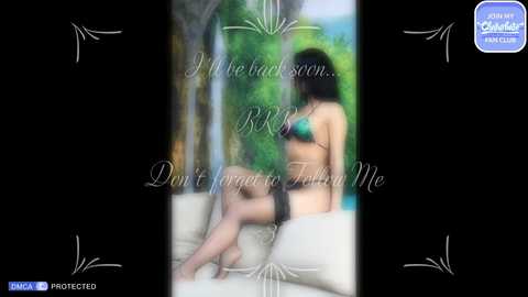 Media: A blurred video of a woman sitting on a white cushion in a lush, tropical garden. She wears a teal bikini and a black bra, her long dark hair flowing. Text overlays: \"I be back soon... Don't forget to feed me.\