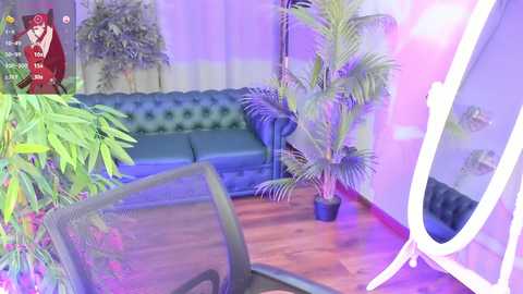 Media: Video of a colorful, vibrant room with a green leather couch, potted plants, and a white floor mirror. The background features a purple curtain and a red cartoon character logo.