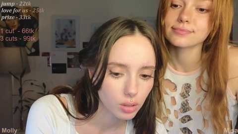 Media: Video of two young women in a cozy room, Molly on the left with long dark hair and a nose ring, and Maddy on the right with long light brown hair and a tattoo.