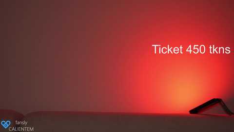 Media: Video of a dimly lit, beige mattress with a red glowing smartphone displaying \"Ticket 450 tkns\" in white text. Background is a gradient of red to orange.