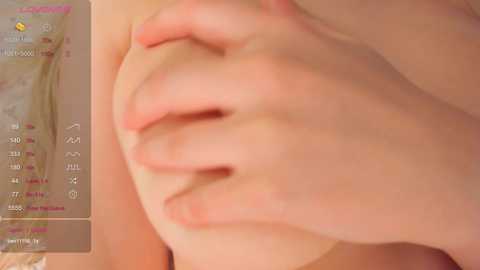 Media: A close-up video of a light-skinned hand grasping a breast, with a calendar displaying dates in the background. The image is intimate and suggestive, focusing on the tactile interaction between fingers and breast.