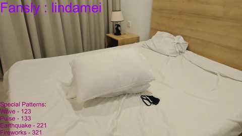 Media: Video of a neatly made bed in a modern hotel room with white linens, a wooden headboard, and a bedside table with a lamp. Text reads \"Family: Incamiel, Spoons, 183, 281, 2321, 231, 291, 321, 291, 321, 291, 321, 291, 321, 291, 321, 291, 321, 291, 321, 291, 321, 291, 321, 291, 321, 291, 321, 291, 321, 291, 321, 291, 321, 291, 321, 291, 321, 291, 321, 291, 321, 291, 321, 291, 321, 291, 321, 291, 321, 291, 321, 291, 321, 291, 321, 291, 321, 291, 321, 291, 321, 291, 321, 291, 321, 291, 321, 291, 321, 291, 321, 291, 321, 291