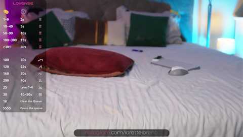 Media: A video of a modern bedroom with a white bed, red pillow, and green pillows, featuring a virtual reality headset and controller.