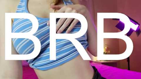 Media: Video of a woman lifting her blue and white striped crop top, revealing a hint of her midriff and cleavage, with the text \"BRB\" superimposed over her torso.