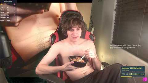 Media: A video of a young, shirtless man with curly hair eating noodles in a red gaming chair. In the background, a live stream screen shows a close-up of his chest.