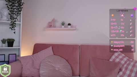 Media: A video of a pink couch with cushions and potted plants, featuring a virtual overlay of a social media feed. The background includes a white shelf with small decor items.