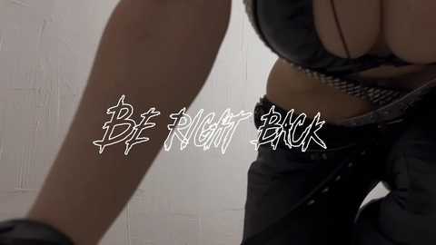 Media: Video of a woman in a black leather bra and pants, with the words \"Breathe Break\" in stylized white graffiti.