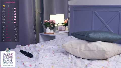 Media: Video of a serene, minimalist bedroom with lavender walls, a white bed with floral bedding, and a blue pillow. A digital display shows a calendar with appointments.