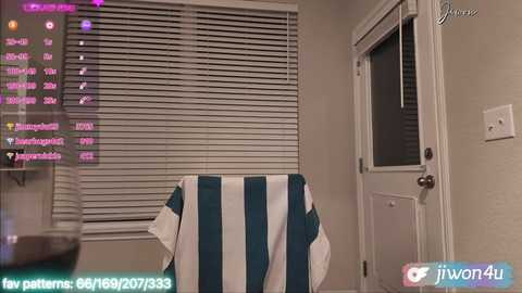 Media: Video of a living room with a white door and horizontal blinds. A teal and white striped shirt hangs on a chair. Text in the corners indicates \"Twin44\" and \"Twin44's Patterns\".