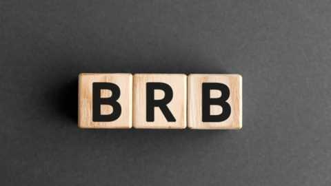 Media: Video of three wooden alphabet blocks spelling \"BRB\" on a dark gray background. The blocks are light-colored wood with bold black letters. The image is clean and minimalistic.