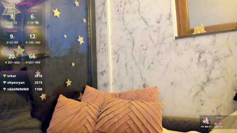 Media: Video of a cozy bedroom with a brown and white striped duvet, a marbled wall adorned with star decals, a framed mirror, and a digital clock showing 20:06.