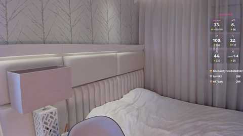 Media: Video of a modern bedroom with a white tufted headboard, white bed, and grey patterned wallpaper. An AR app overlay displays user data, including temperature and humidity.