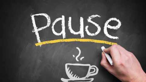 Media: A video shows a hand drawing \"Pause\" in white chalk on a blackboard. A cup of coffee with steam is beneath the word. The board has a yellow line and a ruler.