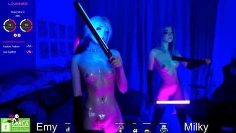 Media: Video of a nude woman with pale skin and long blonde hair, holding a glowing pink bat, in a dimly lit room, possibly a live stream.