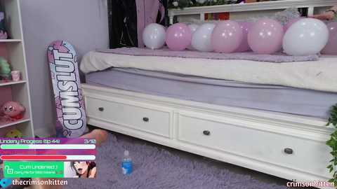 Media: A video of a pink-themed bedroom with a white bed, purple balloons, and a \"Cum Slut\" skateboard on a purple carpet.