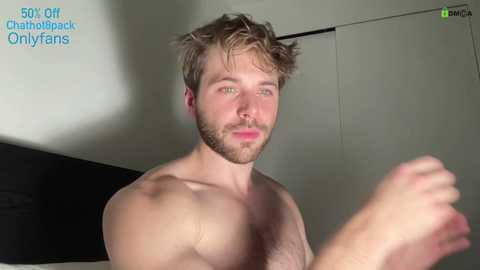 Media: Video of a shirtless, muscular man with tousled brown hair and a beard, in a dimly lit room. Text in the top left reads, \"50% off Chathubback OnlyFans.\