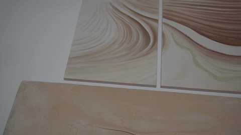 Media: Video of a tiled wall with beige and brown marble-like patterns on square tiles, featuring smooth, swirling textures, and a light wooden plank below.