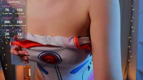 Media: Video of a woman's upper body, partially clothed in a white and red Star Wars-themed top, with a digital overlay displaying health and damage statistics.