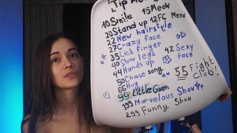 Media: Video of a young woman with long, dark hair, holding a handwritten sign listing 20+ tips and tricks, standing against a blue and black background.