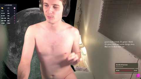 Media: Video of a young, pale-skinned, shirtless man with short brown hair, wearing headphones, indoors near a window, with text overlay.