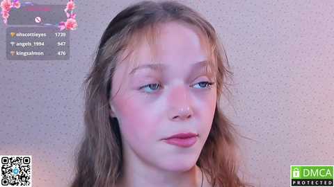 Media: Video of a young girl with light skin, long brown hair, and blue eyes, wearing a nose ring, in a room with a textured, light-colored wall. Text overlays show Instagram statistics.