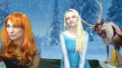 Media: Video of three animated characters: red-haired Elsa, blonde Anna, and Sven the reindeer, with a snowy forest background.