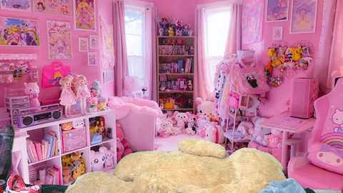 Media: Video of a pink-themed, cozy anime-themed bedroom with plush toys, bookshelves, a gaming chair, and a bed with a green comforter, creating a whimsical and inviting atmosphere.