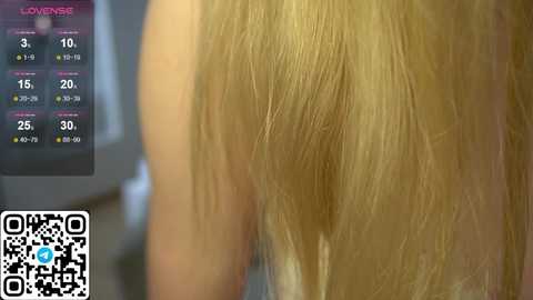 Media: Video of a blonde woman's back, showing the texture of her hair, with a \"LOVIN' LIFE\" calendar and a QR code in the background.