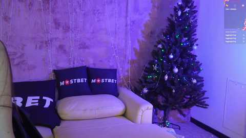 Media: Video of a dimly lit living room with a white couch and two dark pillows reading \"MOST STREET MASTERS\" in white letters. A decorated Christmas tree with blue and silver ornaments stands in the corner.