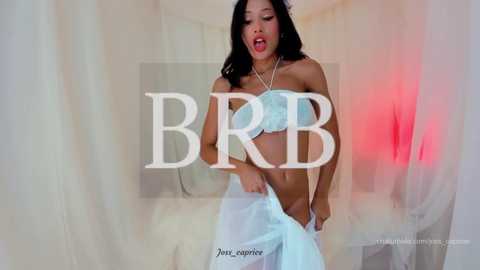 Media: Video of an Asian woman with long black hair, wearing a light blue, strapless lingerie set, standing in a white room. Text overlays \"BBR\" and \"japanese.org.\