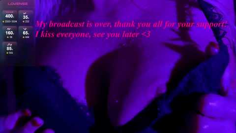 Media: A digital video with a purple hue, featuring a close-up of a woman's cleavage in a black lace bra. Text overlays: \"My broadcast is over, thank you all for your support, see you later <3.\