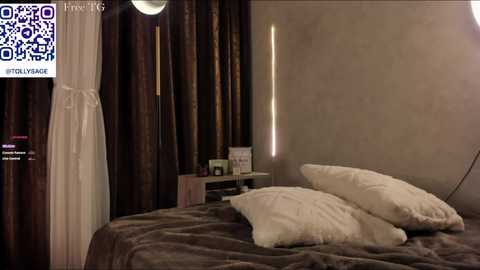 Media: Video of a dimly lit bedroom with a large bed, white pillows, and dark, draping curtains. A QR code and \"Try Eros\" text are visible in the top left corner.