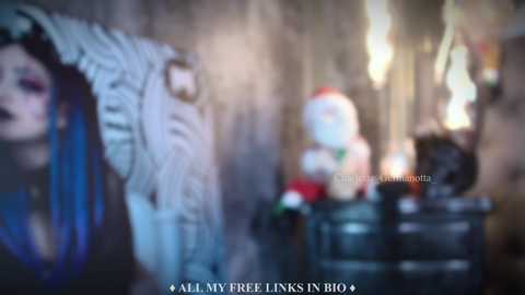 Media: Blurry video of a gothic woman with dark hair and pale skin, surrounded by vintage Christmas decorations and a large, ornate mirror. Text reads \"All My Free Links: https://ift.tt/3h8Dz4P.\