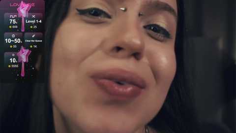 Media: Video of a close-up of a woman with fair skin, black hair, and a silver nose stud, wearing pink lipstick, overlaid with a fitness app interface showing steps, distance, and heart rate.