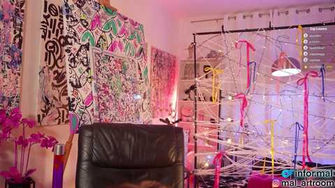 Media: Video of a vibrant, colorful room adorned with abstract graffiti art, pink balloons, and a black leather chair.