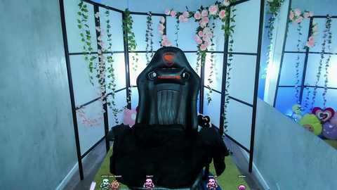 Media: Video of a gaming setup featuring a black gaming chair with a red logo, surrounded by pink and white floral decorations, green carpet, and pink and purple gaming figures on the floor.