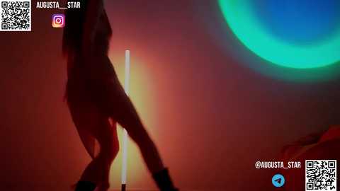 Media: Video of a woman dancing in a dimly lit room, wearing a black dress and high heels. The background features a glowing green circle. Text overlays include a QR code, social media icons, and a watermark.