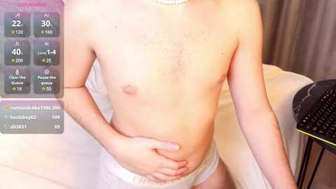 Media: Video of a fair-skinned, shirtless, slim-bodied male with small breasts and white underwear, standing in a bedroom. A digital health monitor displays vital signs in the top left corner.