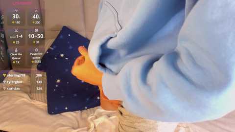 Media: A video of a person wearing a light blue sweatshirt, with a smartphone displaying a starry night sky and health statistics in the background.