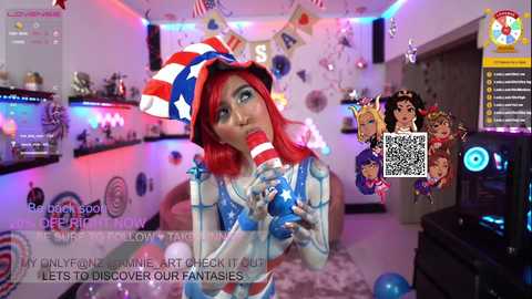 Media: Video of a red-haired woman in an American flag-themed costume, licking a lollipop in a festive, brightly lit room with streamer decorations.