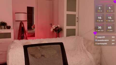 Media: Video of a cozy, pink-lit bedroom with a plush white chair, a furry white throw, and a red floor lamp. A virtual fitness app screen overlays the right side, showing workout stats.