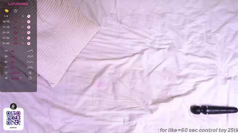 Media: Video of a rumpled white bedsheet with a black vibrator on the side. The image also includes a screenshot of the app \"Lover50\" with a calendar and control buttons visible.